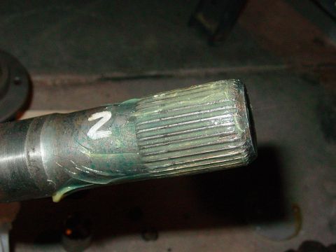 1979 Ford Bronco - Close-up of a greased axle shaft with splines and a visible number '2' marking.