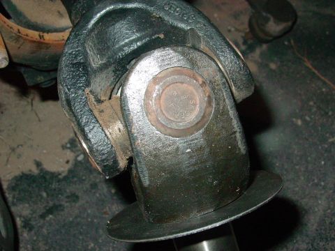 1979 Ford Bronco - Close-up of a vehicle's driveshaft universal joint, focusing on the metal components and fasteners.