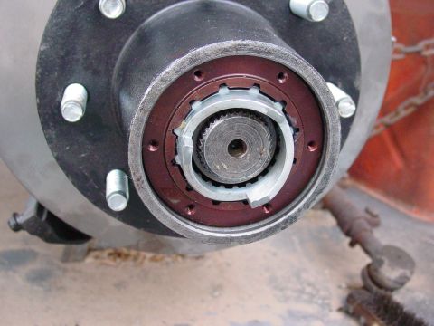 1979 Ford Bronco - Detail of a vehicle's hub assembly, showing the locking mechanism and lug nuts.