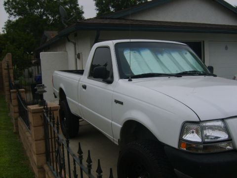1993 Ford Bronco - White Ford Ranger pickup truck parked in a driveway, seen from a 3/4 front angle.
