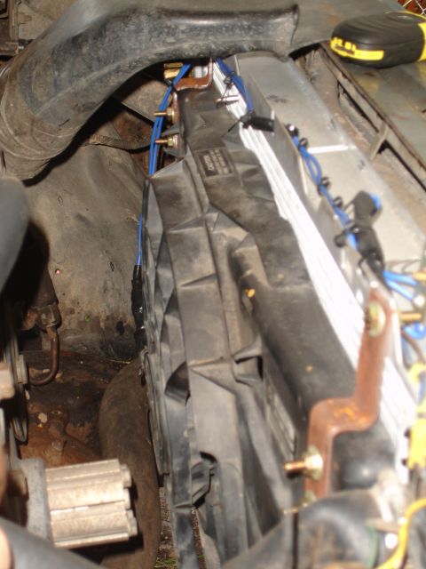 1989 Ford Bronco - Close-up of a vehicle's radiator fan and shroud assembly, with visible wiring modifications.