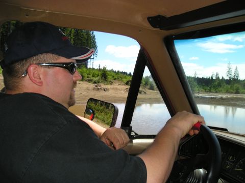 1989 Ford Bronco - Driver navigates an off-road water obstacle in a vintage SUV.