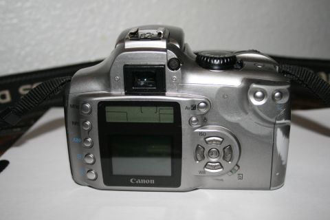 2003 Jeep TJ - A silver Canon digital camera is shown from the rear, displaying its control buttons and LCD screen.