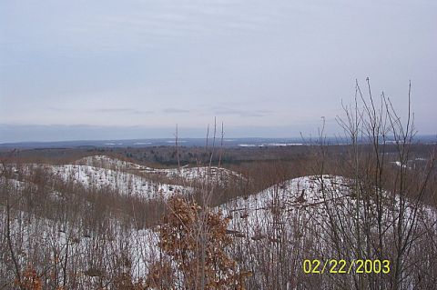 1978 Ford Bronco - A wide view of a winter landscape with snow-covered hills and trees.