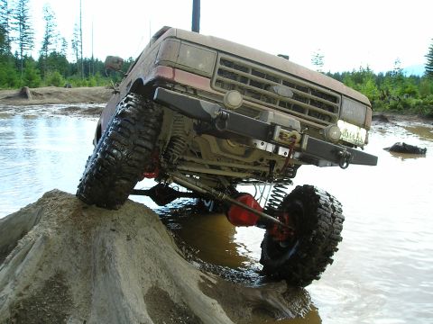 1989 Ford Bronco - This 1989 Ford Bronco is tackling a challenging off-road course with mud and water obstacles.