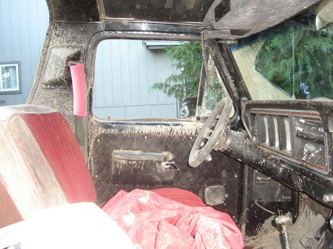 1989 Ford Bronco - Mud-covered interior of a truck, likely after off-roading.