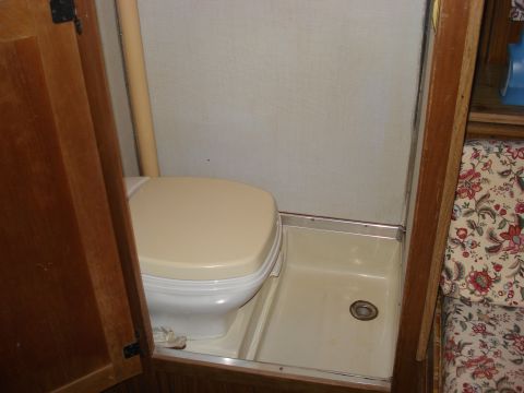 1994 Ford Bronco - Interior view of a camper's bathroom area, showing a toilet and shower stall.