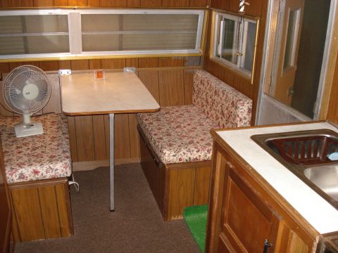 1994 Ford Bronco - Interior view of a camper showing a dinette, a fan, and a sink counter.