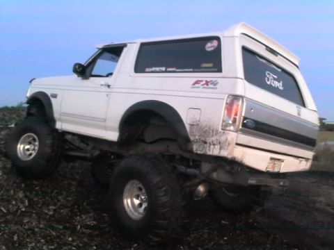 1995 Ford Bronco - This lifted 1995 Ford Bronco is shown in a rear 3/4 view, equipped with large off-road tires.
