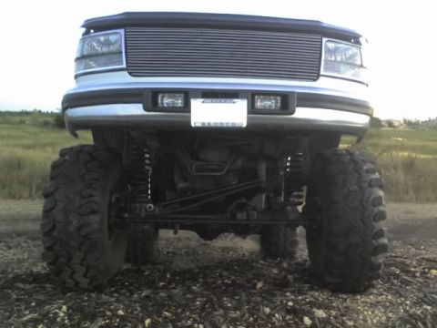 1995 Ford Bronco - Front view of a 1995 Ford Bronco with prominent off-road tires and grille.