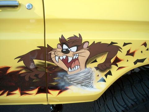 1978 Ford Bronco - Custom airbrush art of the Tasmanian Devil on the side of a yellow vehicle.