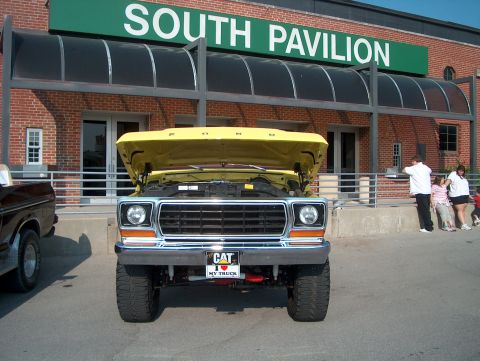1978 Ford Bronco - Front view of a yellow 1978 Ford Bronco with its hood open, parked next to another truck.