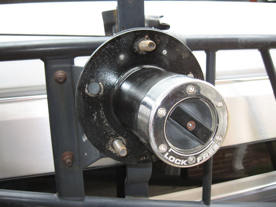 Chrome manual locking hub marked LOCK and FREE on a black painted hub with wheel studs