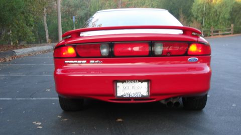 1996 Ford Probe - Rear view of a red 1996 Ford Probe with a spoiler and dual exhaust pipes.