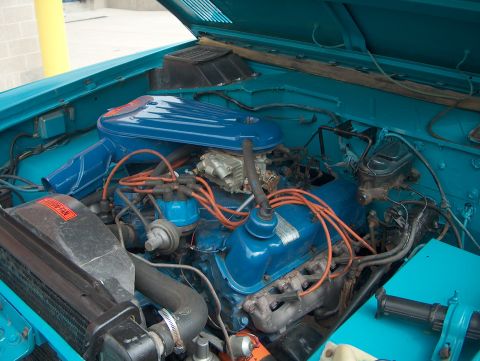 1978 Ford Bronco - The engine bay of a vehicle is shown with various components and wiring visible.