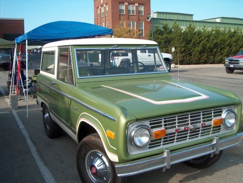 1978 Ford Bronco - This 1978 Ford Bronco features a distinctive green paint job with a white top and a red and white stripe accent on the hood.