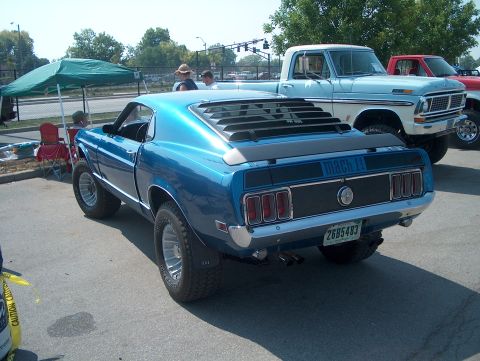 1978 Ford Bronco - Rear view of a lifted 1969 Ford Mustang Mach 1 with louvers and 'Mach 1' badging.