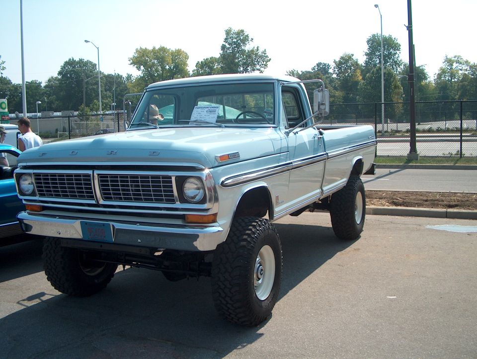 Light blue and white 1970 Ford pickup truck, 3q-front view, lifted suspension