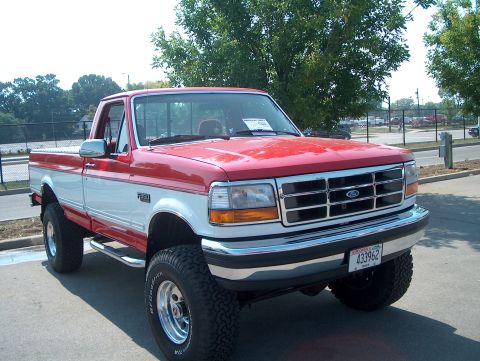 1978 Ford Bronco - This lifted 1992 Ford F-150 pickup truck has a two-tone red and white paint scheme.