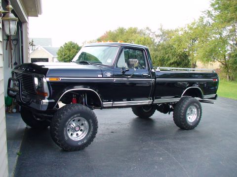 1979 Ford F-250 - This lifted black Ford F-250 features large off-road tires and chrome accents.