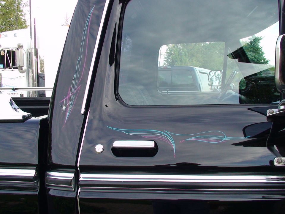 Black 1979 Ford F-250 side view with pinstripes and chrome trim