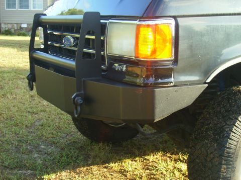 1990 Ford Bronco - Front view of a dark gray Ford Bronco with an aftermarket bumper and brush guard.