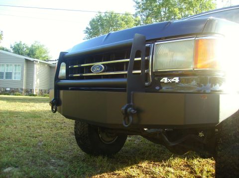 1990 Ford Bronco - Front view of a black 1990 Ford Bronco, equipped with a brush guard and a 4x4 badge.