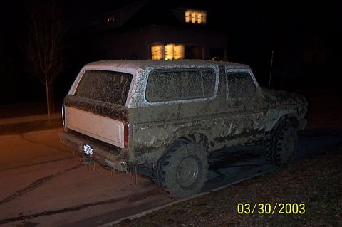 1978 Ford Bronco - This heavily soiled vehicle is parked on a driveway at night, with a house illuminated in the background.