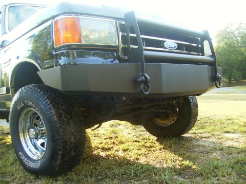 1990 Ford Bronco - Front view of a 1990 Ford Bronco showing its grille, headlights, and custom bumper.