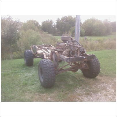 1977 Ford F-150 - This truck chassis is missing its body, showing only the frame, engine, and large tires.