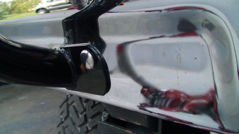 1979 Ford F-250 - A reflection of a red object is visible on the shiny chrome bumper.