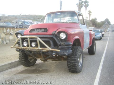 1968 Ford Mustang - This customized GMC pickup truck features off-road tires and a prominent brush guard on the front.