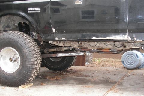 1988 Ford Bronco - Side view of a black 1988 Ford Bronco with modifications, including a lifted suspension and oversized tires.