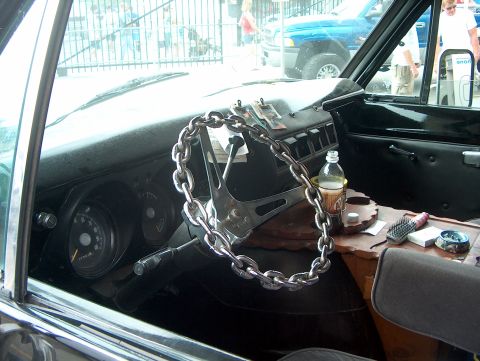 1978 Ford Bronco - The interior of a 1978 Ford Bronco features a unique chain-wrapped steering wheel and a cluttered dashboard.