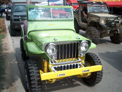 1978 Ford Bronco - A modified Jeep is parked on the street, with other vehicles behind it.