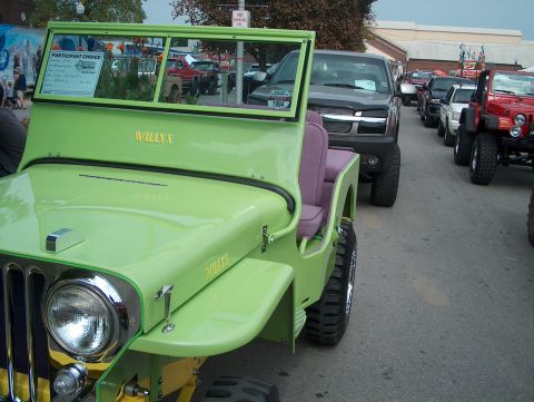 1978 Ford Bronco - A lime green Willys Jeep is parked in a line with other vehicles.