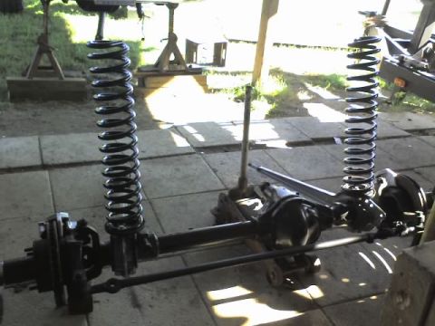 1995 Ford Bronco - Front axle assembly with coil springs and suspension components, likely for a 4x4 vehicle.