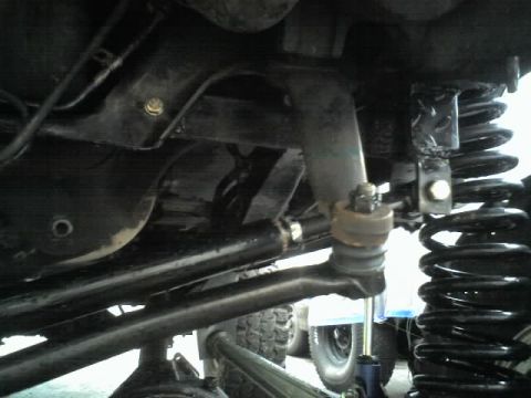 1995 Ford Bronco - Close-up of vehicle suspension parts, with "SUPERMOTORS.NET" visible at the bottom right.