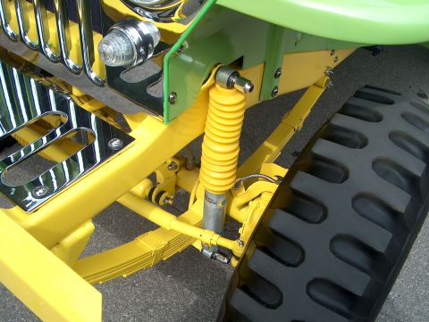 1978 Ford Bronco - Close-up view of the front suspension and tire of a custom-built vehicle.