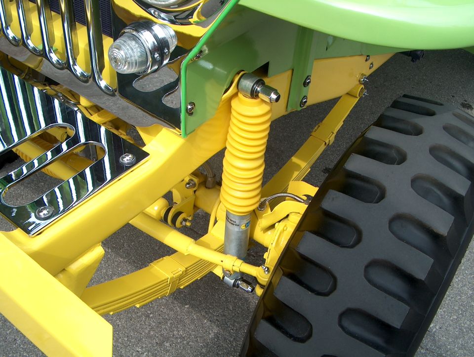 Yellow suspension components and large tire on a custom vehicle