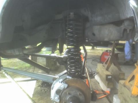 1995 Ford Bronco - Vehicle suspension parts are visible, with a welder and jack stands in the background.