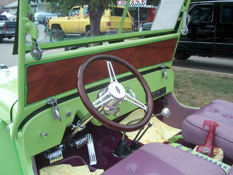 1978 Ford Bronco - Interior view of a custom vehicle with unique upholstery and steering wheel, parked outdoors.