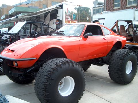 1978 Ford Bronco - This modified vehicle features a classic coupe body atop a lifted chassis with massive off-road tires.