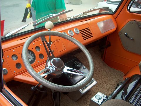 1978 Ford Bronco - The custom interior features an orange dashboard, a glitter steering wheel, and a floor-mounted shifter.