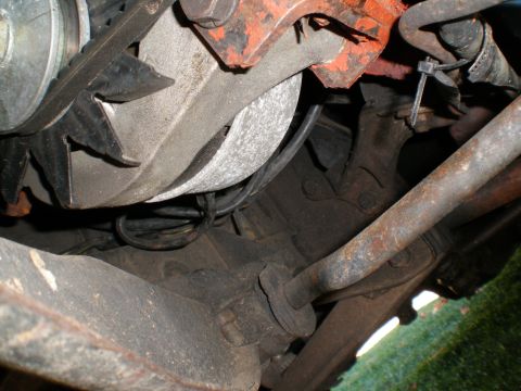 1966 Ford Mustang - Underside view of engine components, including the alternator and associated wiring and belts.