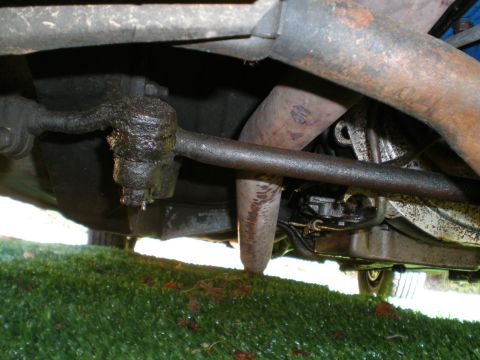1966 Ford Mustang - Close-up of the undercarriage shows a worn steering component and exhaust system.