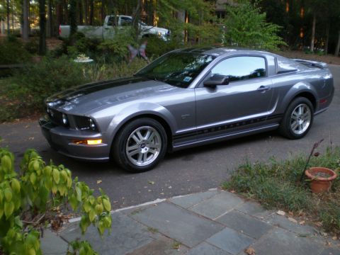 1966 Ford Mustang - This 2005 Ford Mustang GT is parked in a driveway with a white pickup truck in the background.