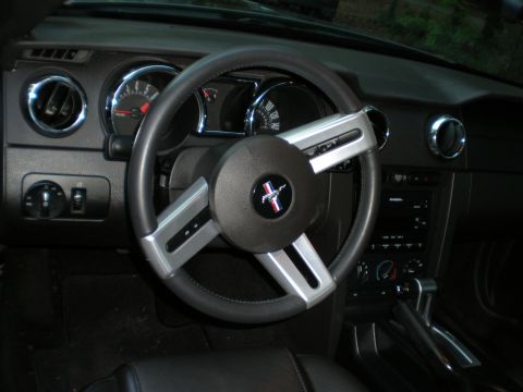 1966 Ford Mustang - The interior of a Ford Mustang, its steering wheel, dashboard, and center console.