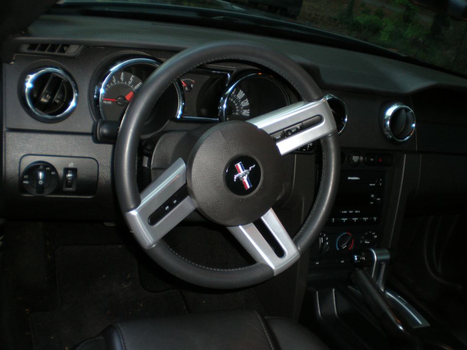 Interior view of a Ford Mustang with a prominent steering wheel and dashboard