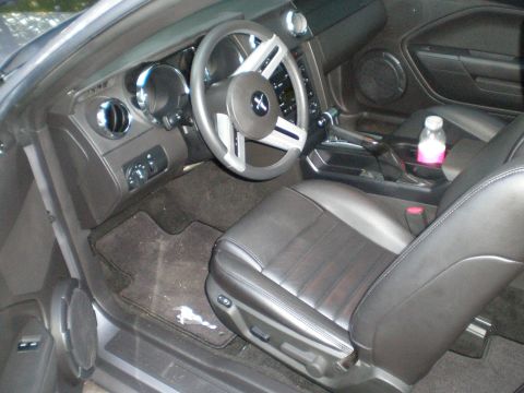 1966 Ford Mustang - Interior view of a car's driver side, including the seat, steering wheel, and dashboard.